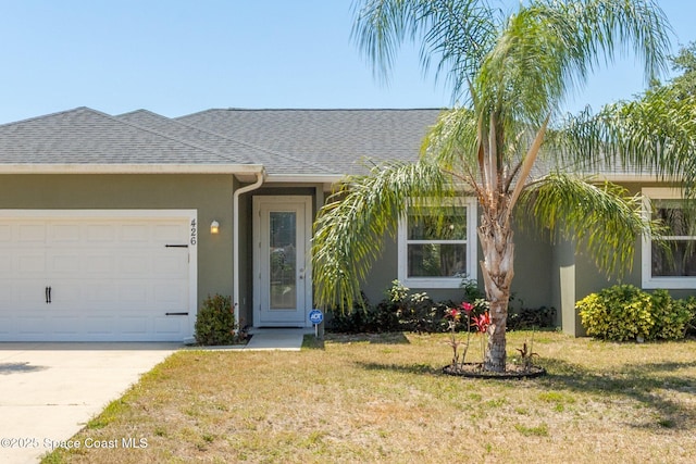 ranch-style home featuring roof with shingles, a garage, stucco siding, a front yard, and driveway