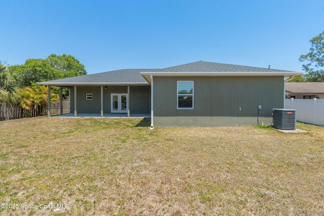 back of house featuring a patio, a fenced backyard, french doors, central AC unit, and a yard