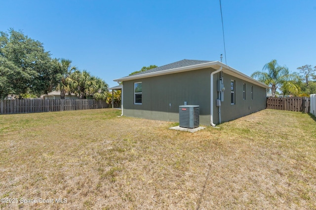 view of property exterior featuring a fenced backyard, stucco siding, a yard, and central AC