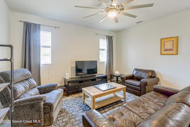 living room with visible vents, ceiling fan, wood finished floors, and a wealth of natural light