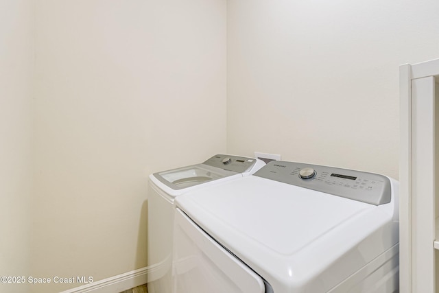 laundry area featuring baseboards, laundry area, and washer and clothes dryer