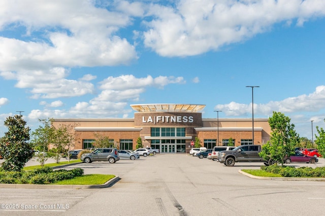 view of building exterior with uncovered parking