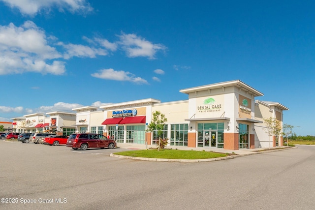 view of building exterior featuring uncovered parking