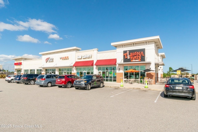 view of property featuring uncovered parking