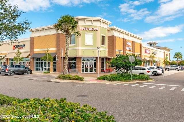 view of building exterior featuring uncovered parking