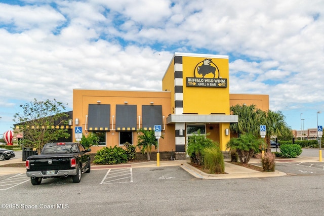 view of building exterior featuring uncovered parking