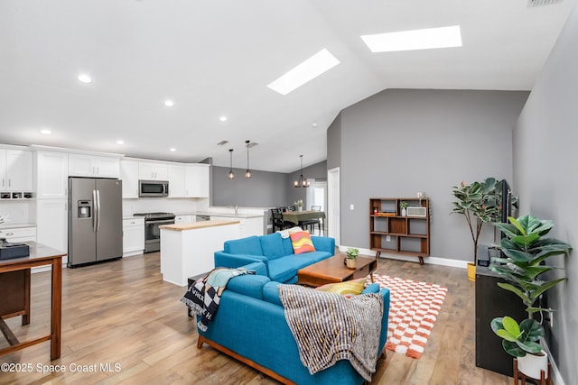 2801 Saint James Ln, Melbourne, FL 32935 - living room with a skylight, light wood-type flooring, recessed lighting, and high vaulted ceiling