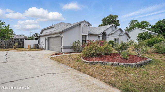 2615 Slash Pine Ct, Titusville, FL 32780 - ranch-style home featuring driveway, central air condition unit, fence, an attached garage, and stucco siding