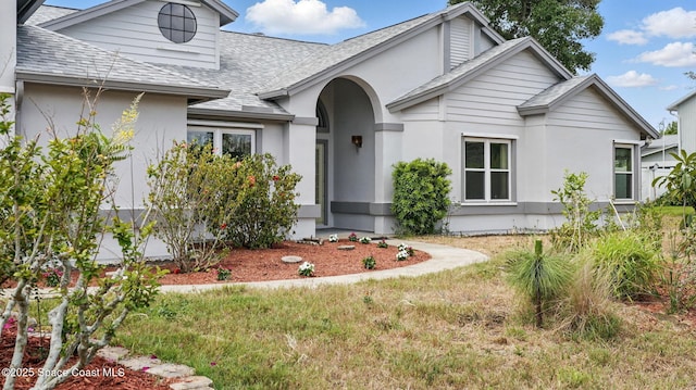 2615 Slash Pine Ct, Titusville, FL 32780 - view of front facade with a shingled roof and stucco siding