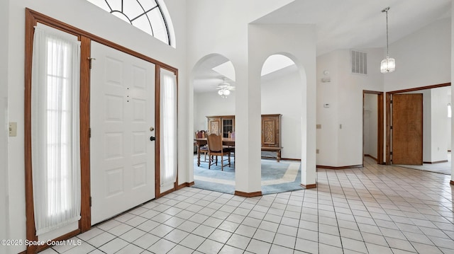 2615 Slash Pine Ct, Titusville, FL 32780 - entrance foyer with light tile patterned flooring, high vaulted ceiling, visible vents, and baseboards