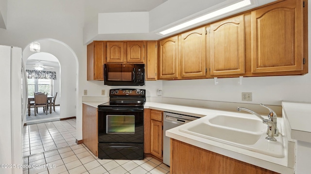 2615 Slash Pine Ct, Titusville, FL 32780 - kitchen featuring light countertops, light tile patterned floors, a sink, and black appliances