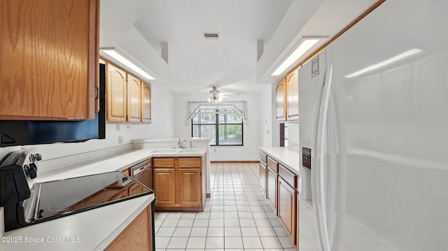 2615 Slash Pine Ct, Titusville, FL 32780 - kitchen featuring ceiling fan, white refrigerator with ice dispenser, light tile patterned floors, light countertops, and a peninsula