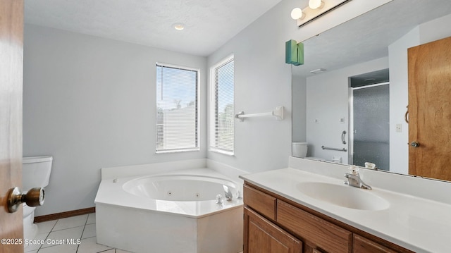 2615 Slash Pine Ct, Titusville, FL 32780 - bathroom featuring a jetted tub, a stall shower, vanity, tile patterned floors, and toilet