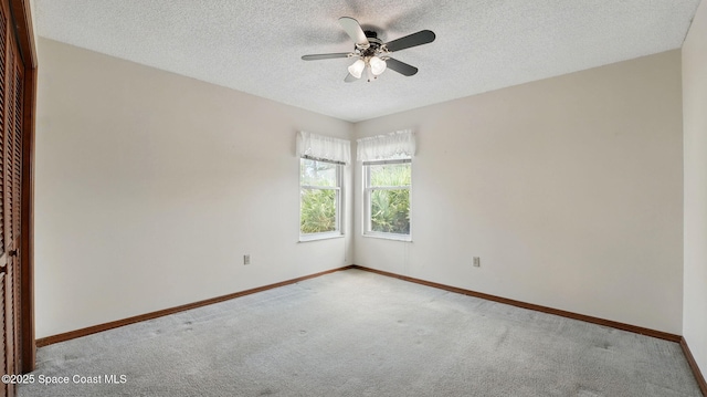2615 Slash Pine Ct, Titusville, FL 32780 - spare room with baseboards, carpet flooring, a textured ceiling, and ceiling fan
