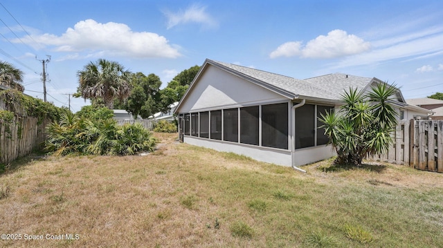 2615 Slash Pine Ct, Titusville, FL 32780 - back of property with a lawn, a sunroom, and a fenced backyard