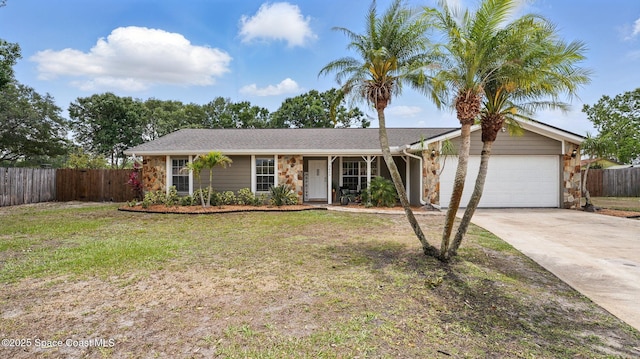 ranch-style house with fence, a front yard, stone siding, concrete driveway, and an attached garage