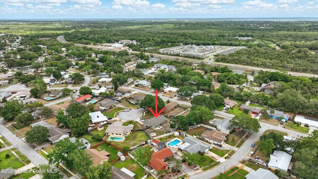 drone / aerial view with a residential view and a forest view