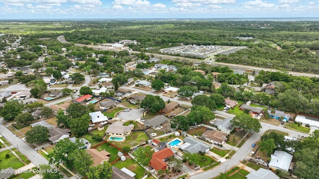 drone / aerial view with a view of trees and a residential view