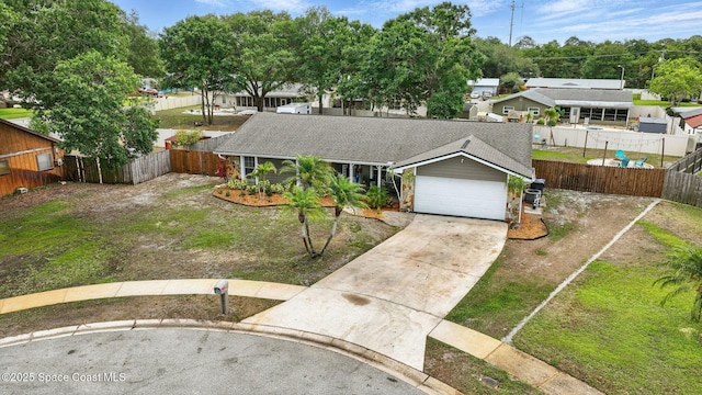 view of front facade featuring an attached garage, fence, a shingled roof, and driveway