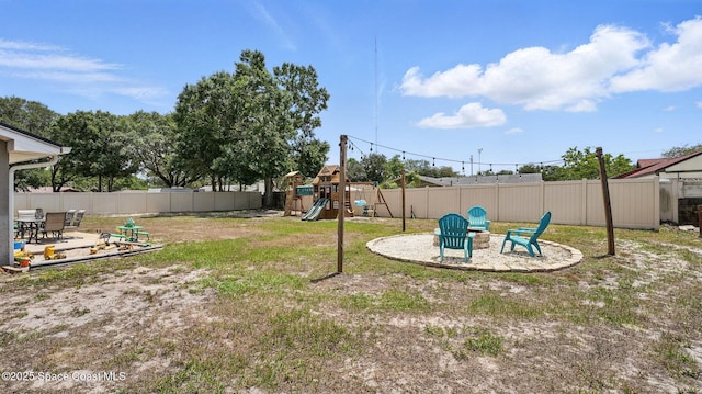 view of yard featuring a patio, a fenced backyard, and a playground