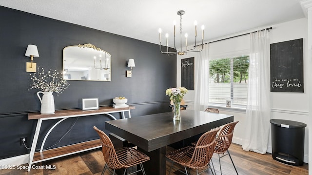 dining room featuring baseboards, an inviting chandelier, and wood finished floors