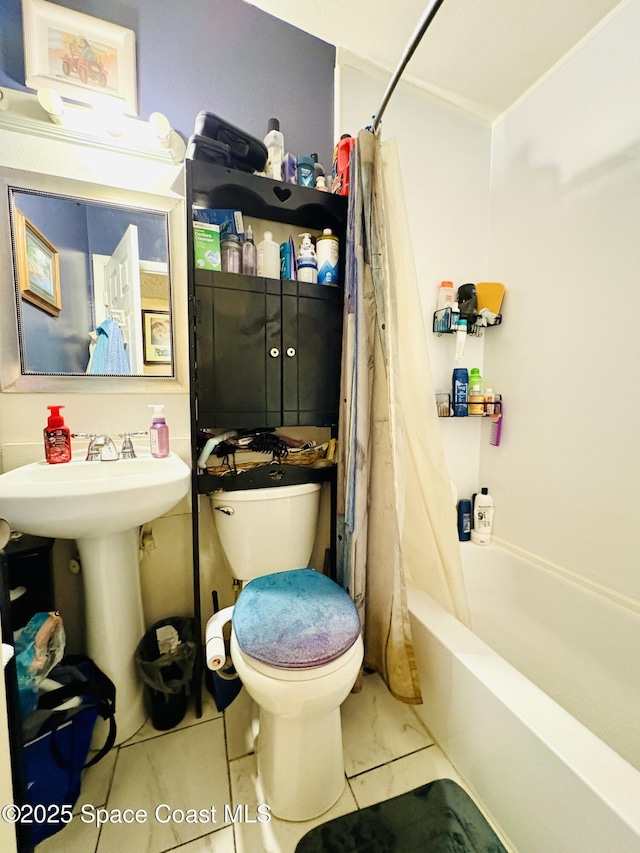 bathroom with toilet, shower / bathtub combination with curtain, and a sink