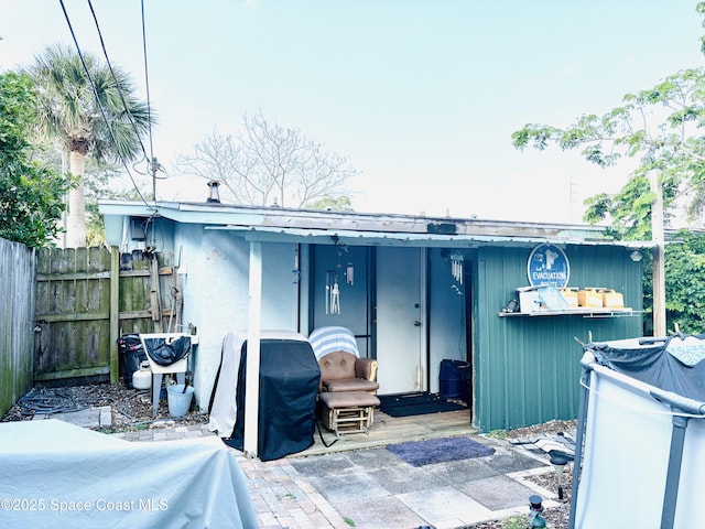 exterior space featuring fence and stucco siding