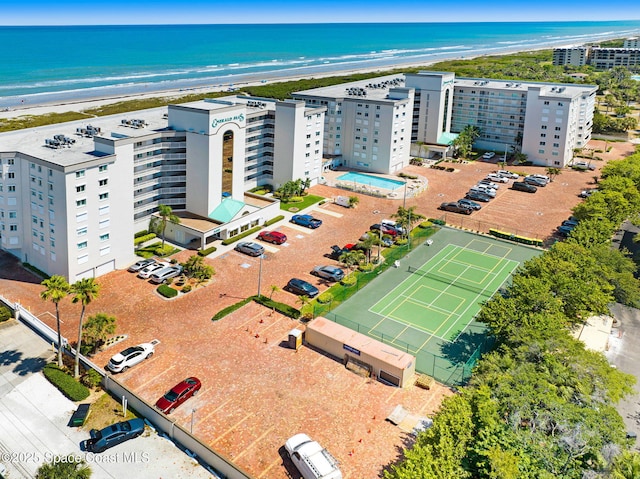 birds eye view of property with a beach view and a water view
