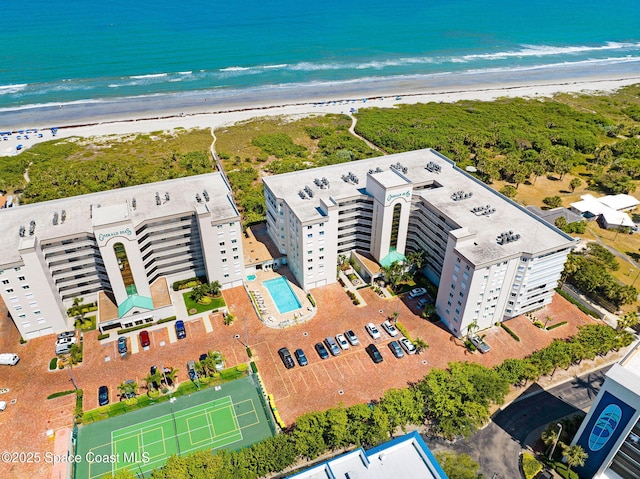 birds eye view of property featuring a view of the beach and a water view
