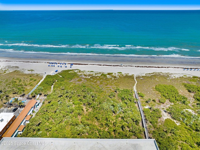 drone / aerial view featuring a water view and a beach view