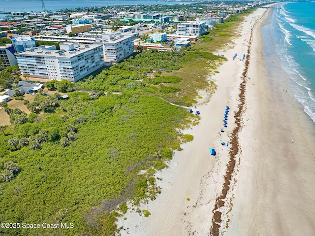 bird's eye view with a water view, a view of city, and a beach view