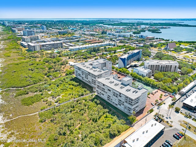 birds eye view of property with a view of city and a water view
