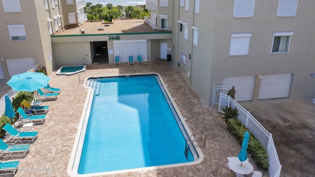 pool with fence and a patio area
