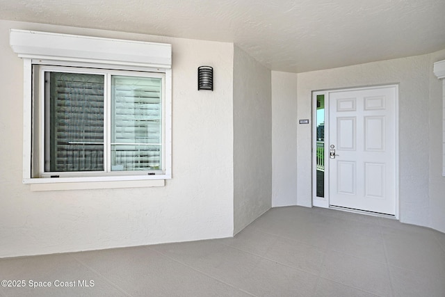 view of exterior entry with stucco siding