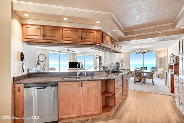 kitchen with stainless steel dishwasher, ornamental molding, a sink, and a wealth of natural light