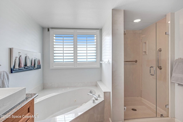 full bath featuring a tub with jets, a stall shower, and vanity