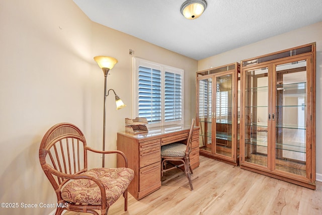 home office with french doors and light wood-type flooring