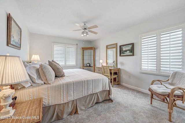 carpeted bedroom with baseboards and ceiling fan