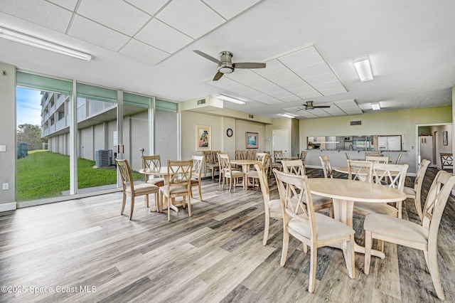 dining area with visible vents, ceiling fan, and wood finished floors