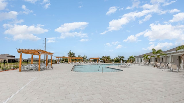 pool with a patio and a pergola