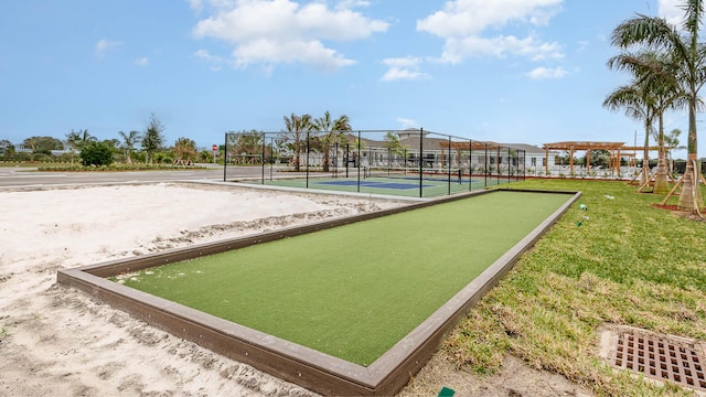surrounding community with fence and a tennis court