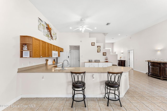 3502 Tipperary Dr, Merritt Island, FL 32953 - kitchen with white appliances, a peninsula, ceiling fan, light countertops, and recessed lighting