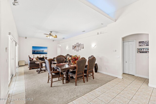 3502 Tipperary Dr, Merritt Island, FL 32953 - dining area with light tile patterned flooring, light colored carpet, ceiling fan, and baseboards