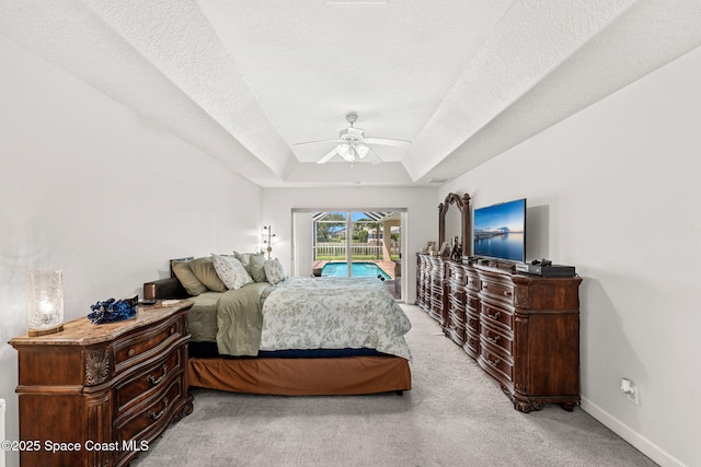 3502 Tipperary Dr, Merritt Island, FL 32953 - bedroom with access to outside, light colored carpet, a raised ceiling, baseboards, and a ceiling fan