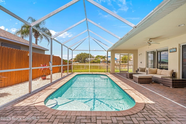3502 Tipperary Dr, Merritt Island, FL 32953 - view of swimming pool featuring a patio, a ceiling fan, a fenced backyard, an outdoor living space, and glass enclosure