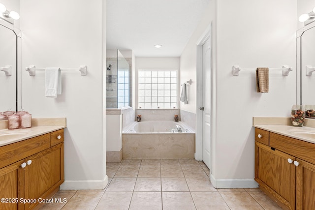 3502 Tipperary Dr, Merritt Island, FL 32953 - full bath featuring two vanities, a whirlpool tub, tile patterned floors, and baseboards