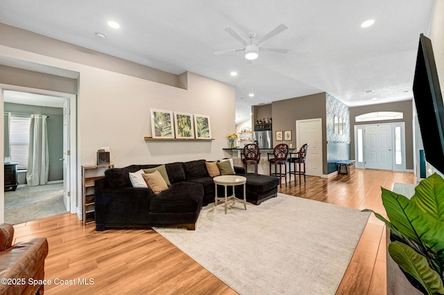 living area with a ceiling fan, recessed lighting, and light wood finished floors