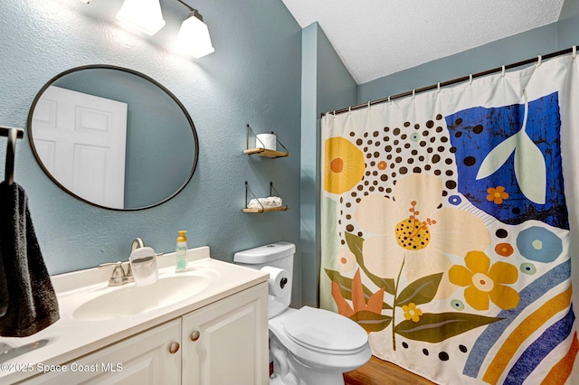 full bathroom with vanity, a textured wall, toilet, a shower with shower curtain, and a textured ceiling