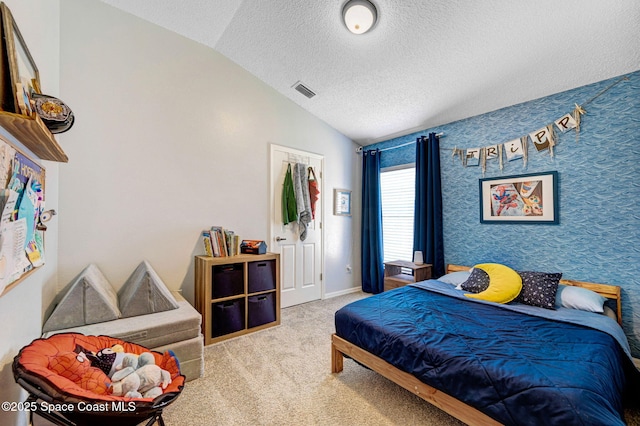 bedroom featuring carpet floors, a textured ceiling, baseboards, lofted ceiling, and visible vents