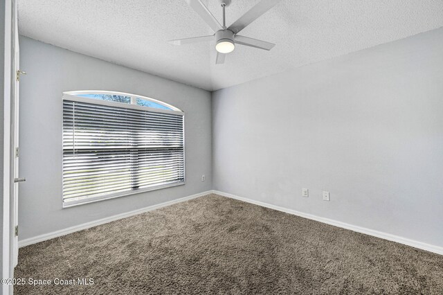 empty room featuring carpet floors, a ceiling fan, a textured ceiling, and baseboards